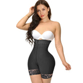 A woman wearing a white strapless bra and black seamless shapewear bodysuit with lace accents on the leg openings.